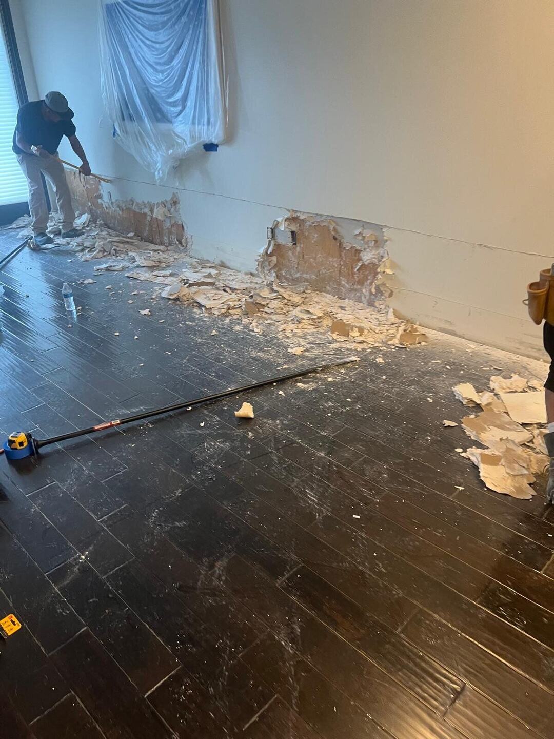Opening up affected baseboard and drywall