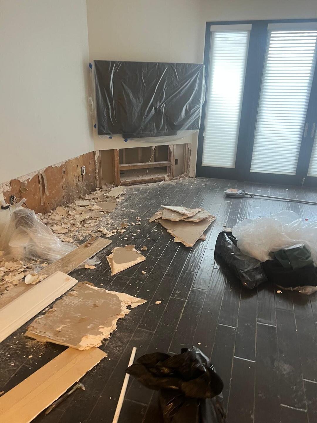 Living area floor removed, debris and containment plastic